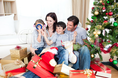 Happy family having fun with Christmas presents