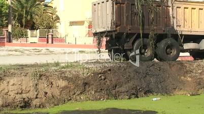 Silt pouring from truck after dredging canal 2