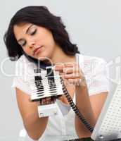 Businesswoman on phone and looking at an index holder