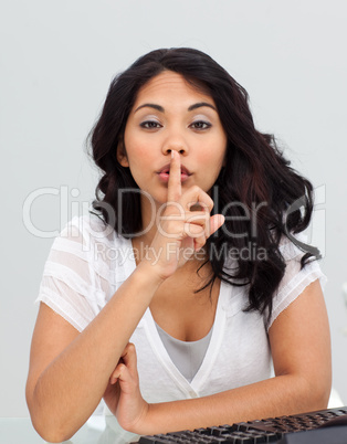 Ethnic businesswoman asking for silence in the office