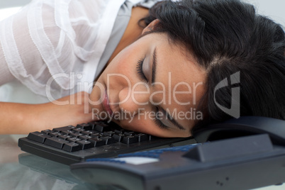 Young businesswoman sleeping on the keyboard