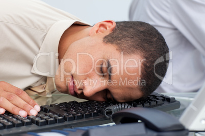 Young businessman sleeping on the laptop
