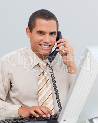 Young businessman talking on phone in the office