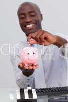 Afro-American businessman saving money in a piggybank