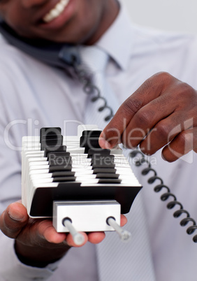 Businessman on phone and looking at an index holder