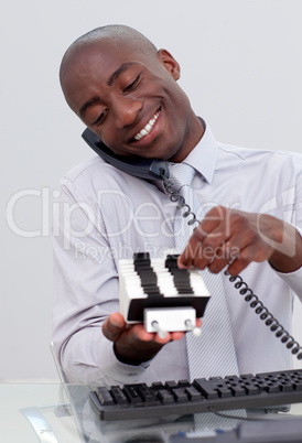 Businessman on phone and looking at an index holder