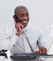 Afro-American businessman on phone in the office