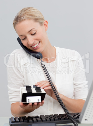 Businesswoman on phone and looking at an index holder