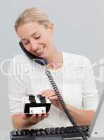 Businesswoman on phone and looking at an index holder