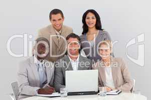 Happy multi-ethnic business team working in office together