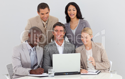 Smiling multi-ethnic business team working in office together