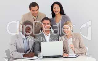 Smiling multi-ethnic business team working in office together