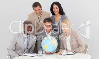 Multi-ethnic business team holding a terrestrial globe