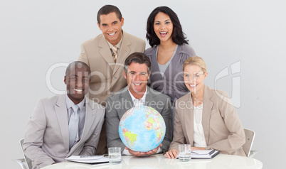 Business team holding a terrestrial globe