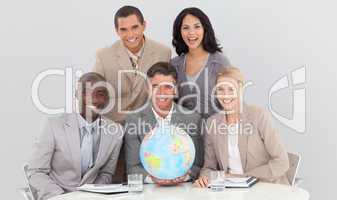 Business team holding a terrestrial globe