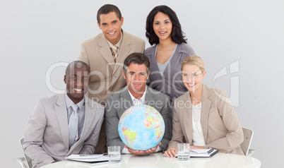 Multi-ethnic business team holding a terrestrial globe