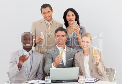 Multi-ethnic business team celebrating a success with champagne