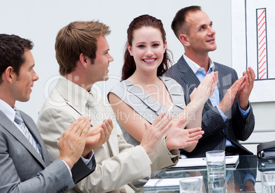 Attractive businesswoman applauding in a meeting