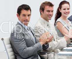 Attractive businessman applauding in a meeting