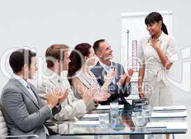 Business team applauding a colleague after giving a presentation
