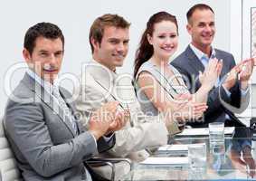 Business team applauding in a meeting