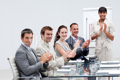 Business people applauding a colleague after giving a presentati