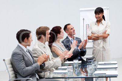 Business people applauding a colleague after giving a presentati