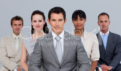 Multi-ethnic business team sitting in front of the camera