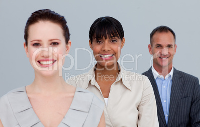 Smiling two businesswomen and a businessman