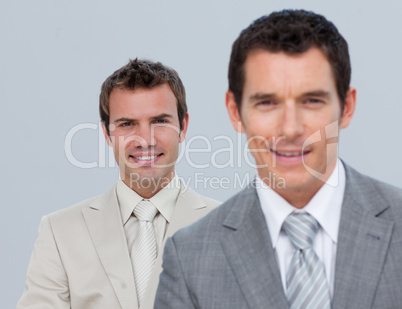 Two businessmen smiling at the camera