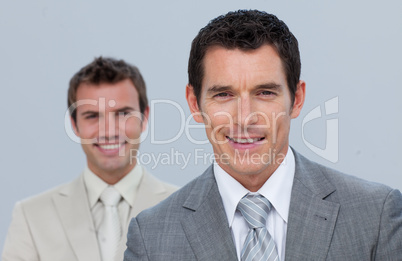 Two businessmen smiling at the camera
