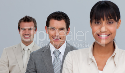 Two businessmen and a businesswoman smiling at the camera
