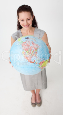 Smiling businesswoman holding a terrestrial globe