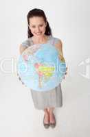 Beautiful businesswoman holding a terrestrial globe