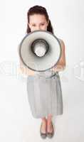 High angle of a businesswoman shouting through a megaphone