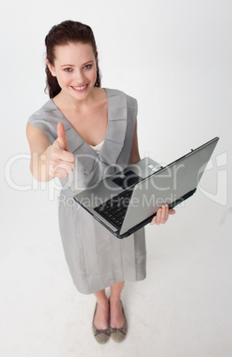 High angle of a businesswoman using a laptop with thumb up