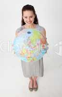 Young businesswoman holding the Earth planet