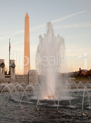 Washington Monument behind fountain at sunset
