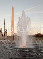 Washington Monument behind fountain at sunset