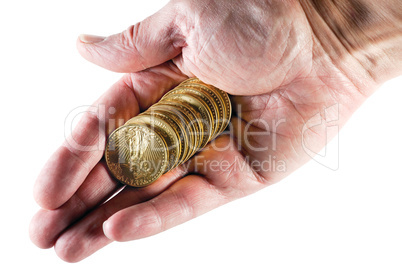 Stack of ten gold coins in hand