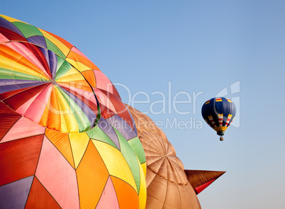 Hot air balloon in the air above two others
