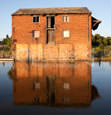 Reflection of red brick warehouse in Ellesmere Canal