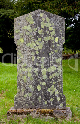 Old grave marker with lichen and moss