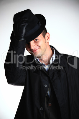 Man with hand on hat