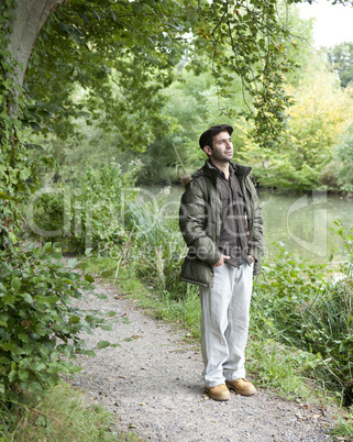 Man standing on a canal towpath.