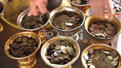 Filling Temple Containers With Coins