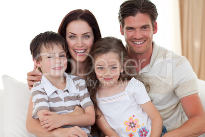 Portrait of a smiling family on the sofa