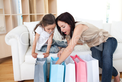Mother and daughter unpacking shopping bags