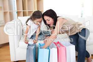 Mother and daughter unpacking shopping bags