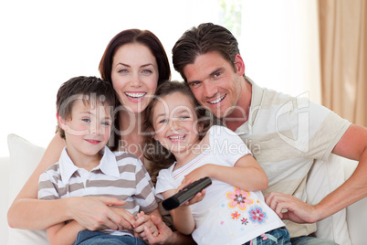 Portrait of a happy family watching TV